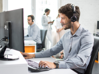 Smiling handsome customer support operator agent with hands-free